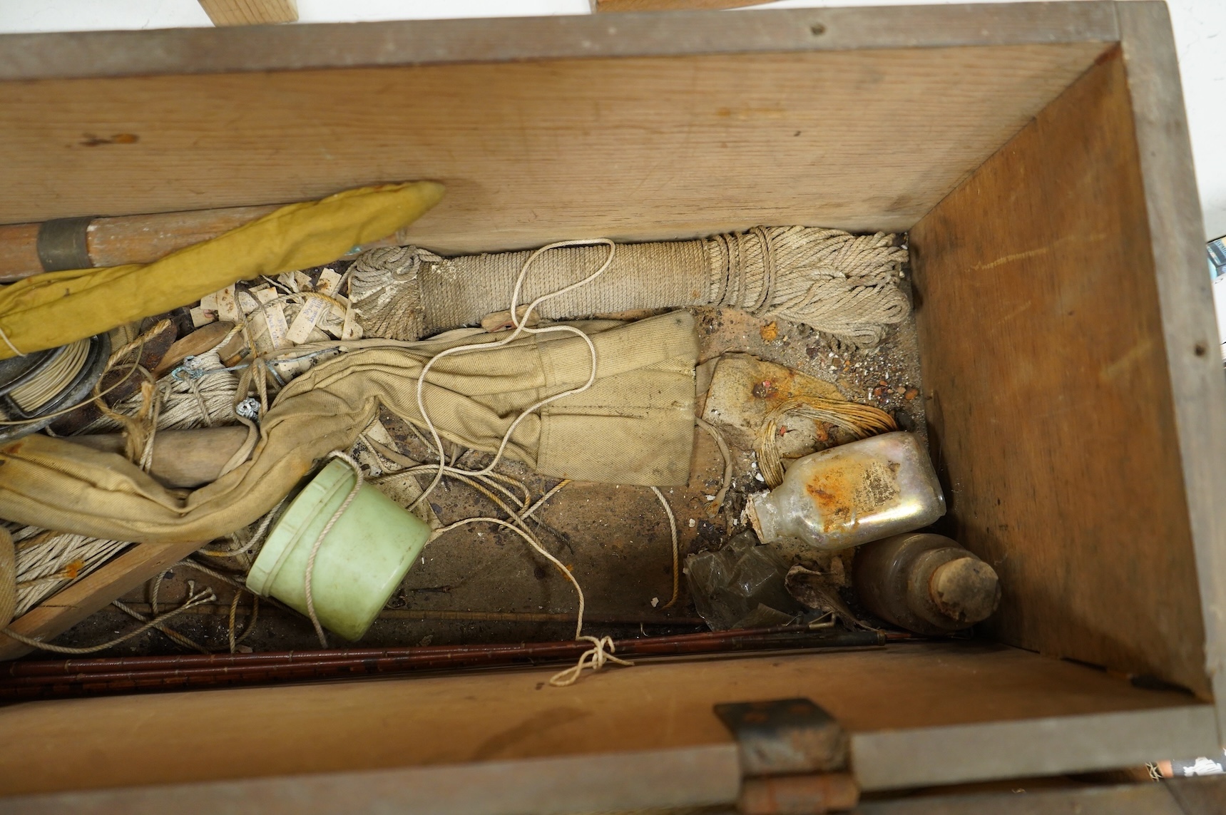 A collection of split cane fishing rods, reels, landing net etc contained in a large wooden box